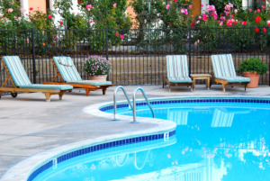 beautiful swimming pool surrounded by chairs and flowers